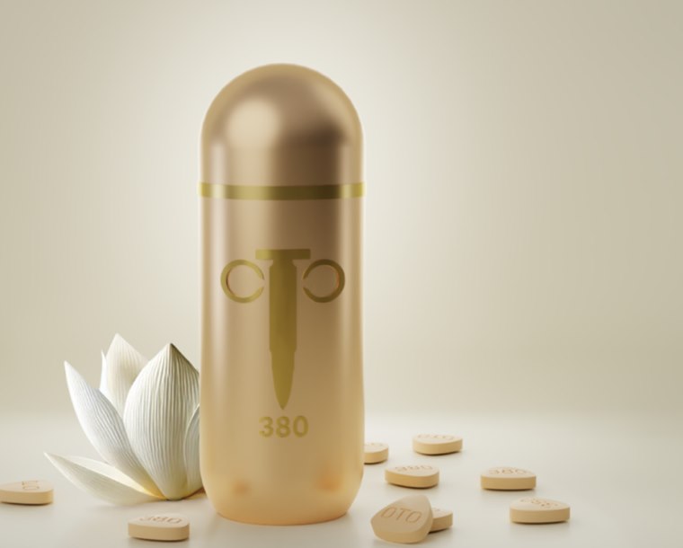 Golden Bullet 380 capsule with snow lotus flower and loose tablets on a cream background
